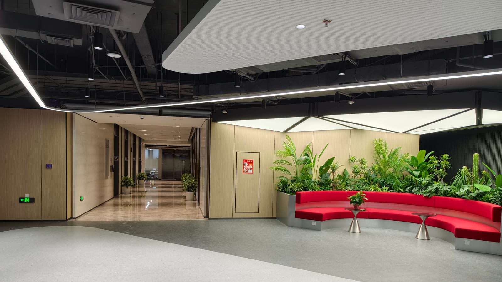 Lounge and breakout area in our Hong Kong office, with a curved bench and plants.